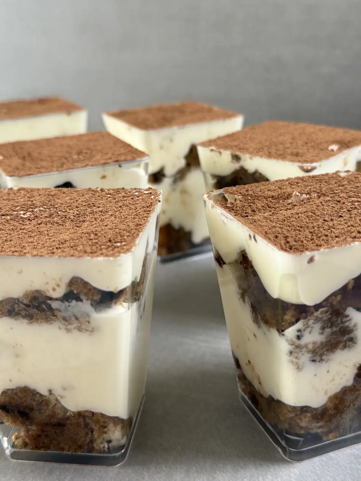 Layered pudding cups dusted with cocoa